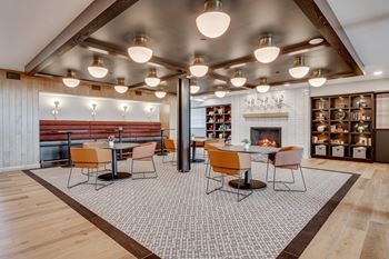 a dining area with tables and chairs and a fireplace